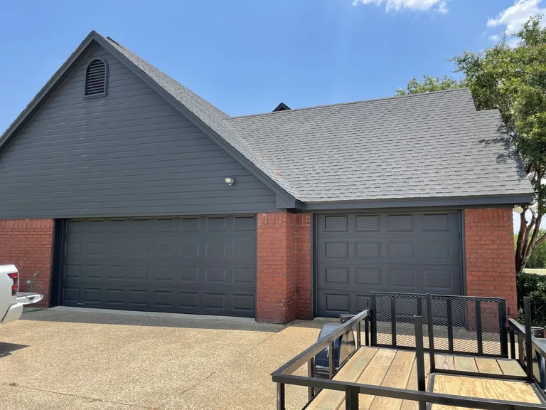 Charcoal garage doors and gable siding